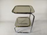a metal table with two trays on top of it
