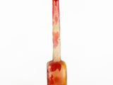 an orange glass vase with a picture of a woman on it