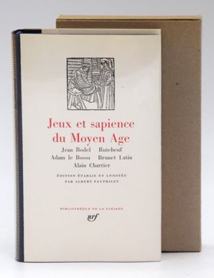 an old book sitting on top of a table next to a box