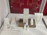 a display case with a variety of necklaces and bracelets on it
