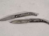 two knives that are sitting on a table