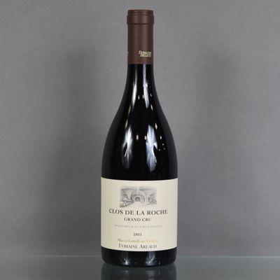 a bottle of wine sitting on a glass table