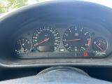 a close up of a car dashboard with a speedometer and gauges