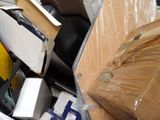 a pile of boxes and other items in the back of a truck