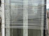 a large window that has been wrapped up and ready to be installed