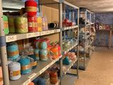 many shelves with different colored items on them in a store