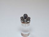 a close up of a ring with a flower on top of it