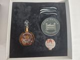 a picture of a bottle of perfume and a medal