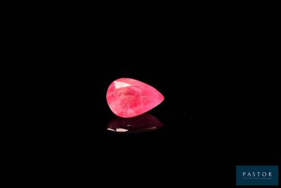 a pink diamond on a black background