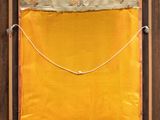 an image of a yellow piece of art hanging on a wall