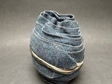 grey felt bag with a string tied around it