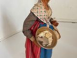 figurine of an old woman with a hat and a basket