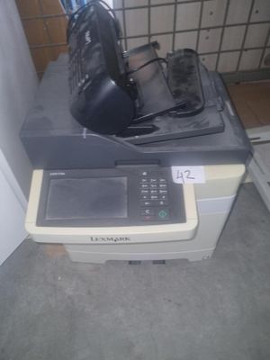 a printer sitting on top of a desk next to a wall