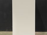 tall white planter with a white base and a black background