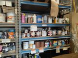 many shelves of paint and other paints in a room