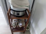 a stack of towels on a small shelf in the corner of a room