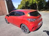 the rear end of a red car parked in a parking lot