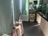 bags of food sitting on the floor in the kitchen