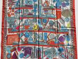 an image of a red and white scarf with a picture of various objects
