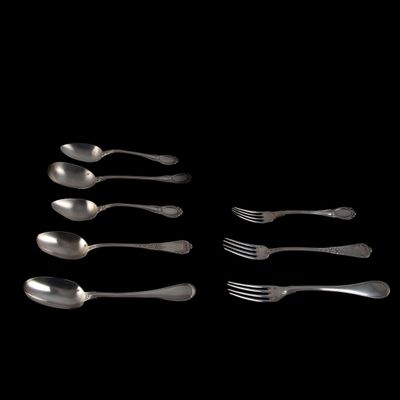 six cuillères et une fourchette sur fond noir