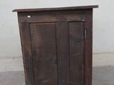 a small wooden cabinet with a door on the top