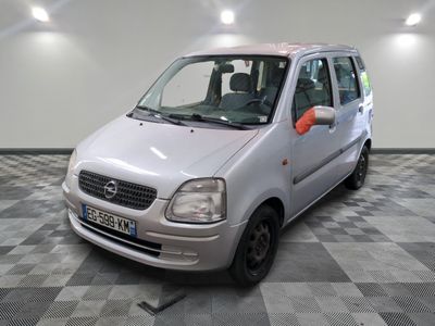 une petite voiture argentée garée dans une pièce au sol en damier