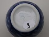 a blue and white vase with a number on it