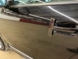 a black car with a silver door handle and a silver door handle