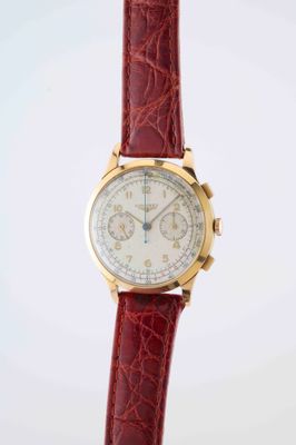 a close up of a wrist watch with a red strap