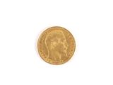 a close up of a gold coin on a white surface
