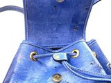 a blue purse that is sitting on top of a table