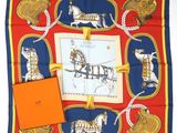 blue, red, and gold scarf with a picture of a horse drawn carriage