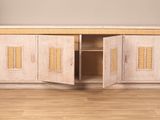 a wooden cabinet with two doors open on a hard wood floor
