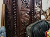 a large wooden armoire in the middle of a room