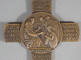 gold plated cross with a religious image of a man and a woman