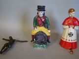 two figurines of a man and a woman sitting next to each other