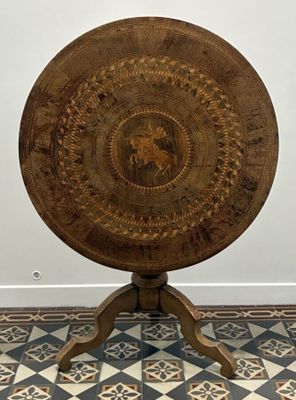 a wooden table with a circular design on top of it