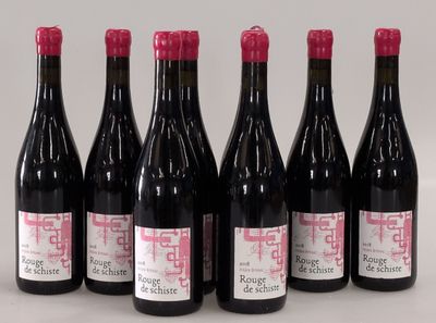 six bottles of wine are lined up in a row on a table