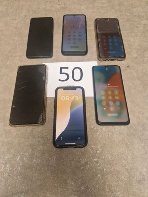 four iphones are sitting next to each other on a table