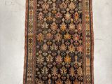 an old rug is displayed on a white surface