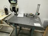 an image of a workbench in a lab with a microscope on it