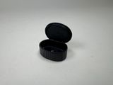 a small black container with a lid on a white surface