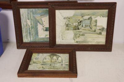 two framed pictures of a man and a woman in a kitchen