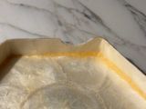 a close up of a pie pan on a marble table