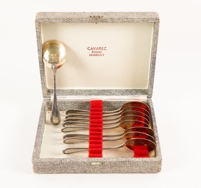silverware in a box with a red ribbon and spoons in it