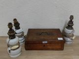 a small wooden box sitting on a table next to two small vases