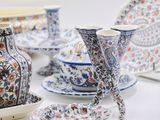many different types of vases and plates on the table