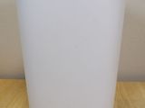 an image of a white trash can on a wooden table