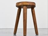 an image of a wooden stool in a white room