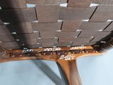 a close up of a wooden chair with a brown seat